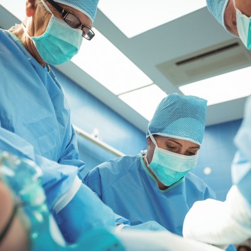 Team of surgeons performing operation in operation theater at hospital